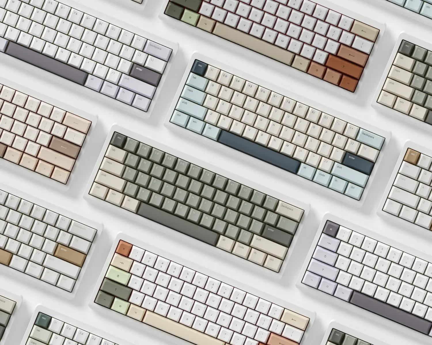 A collection of osume keyboards in soft green, lavender and neutral colourways